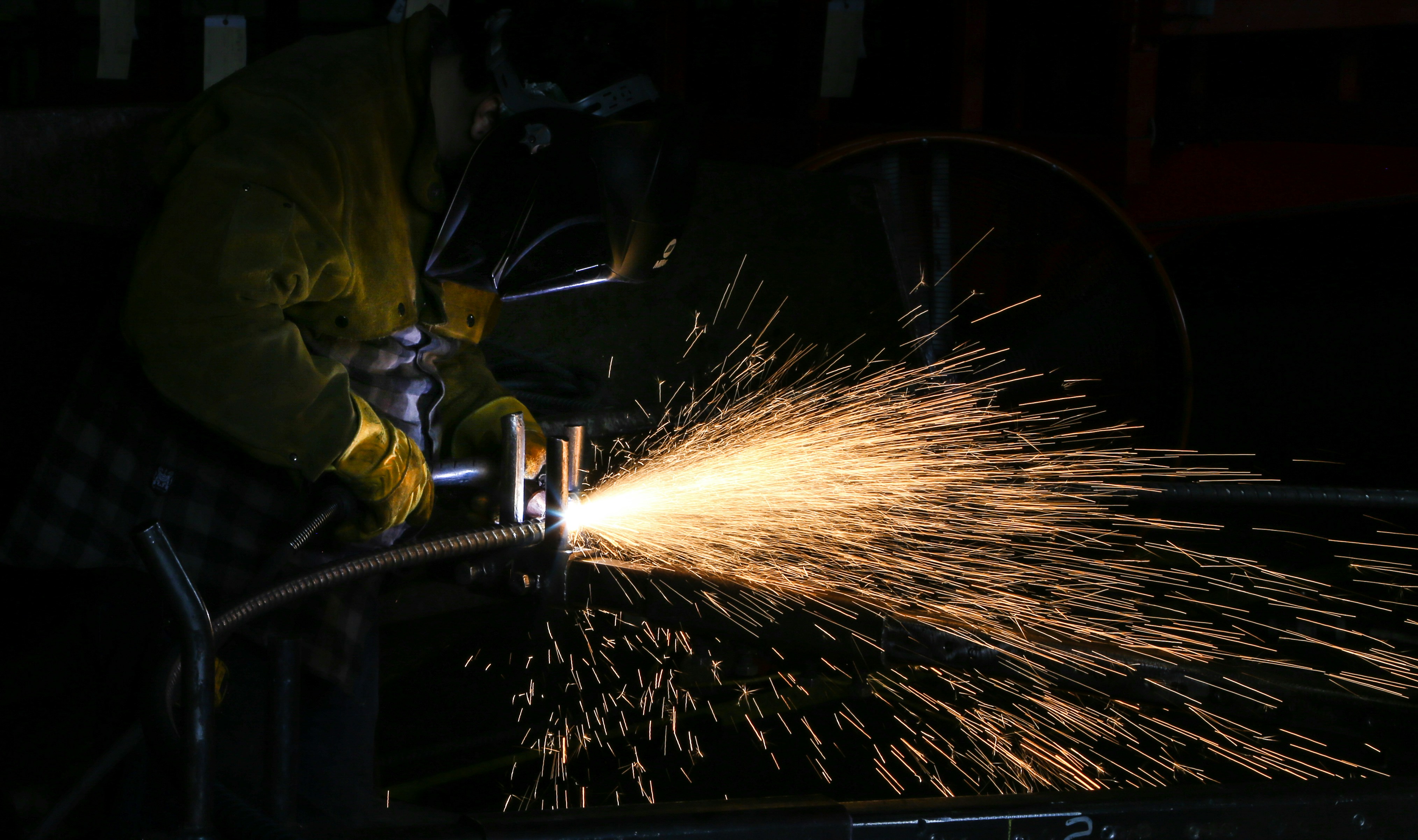Welder working with sparks flying — skilled trades image for ATS resume article