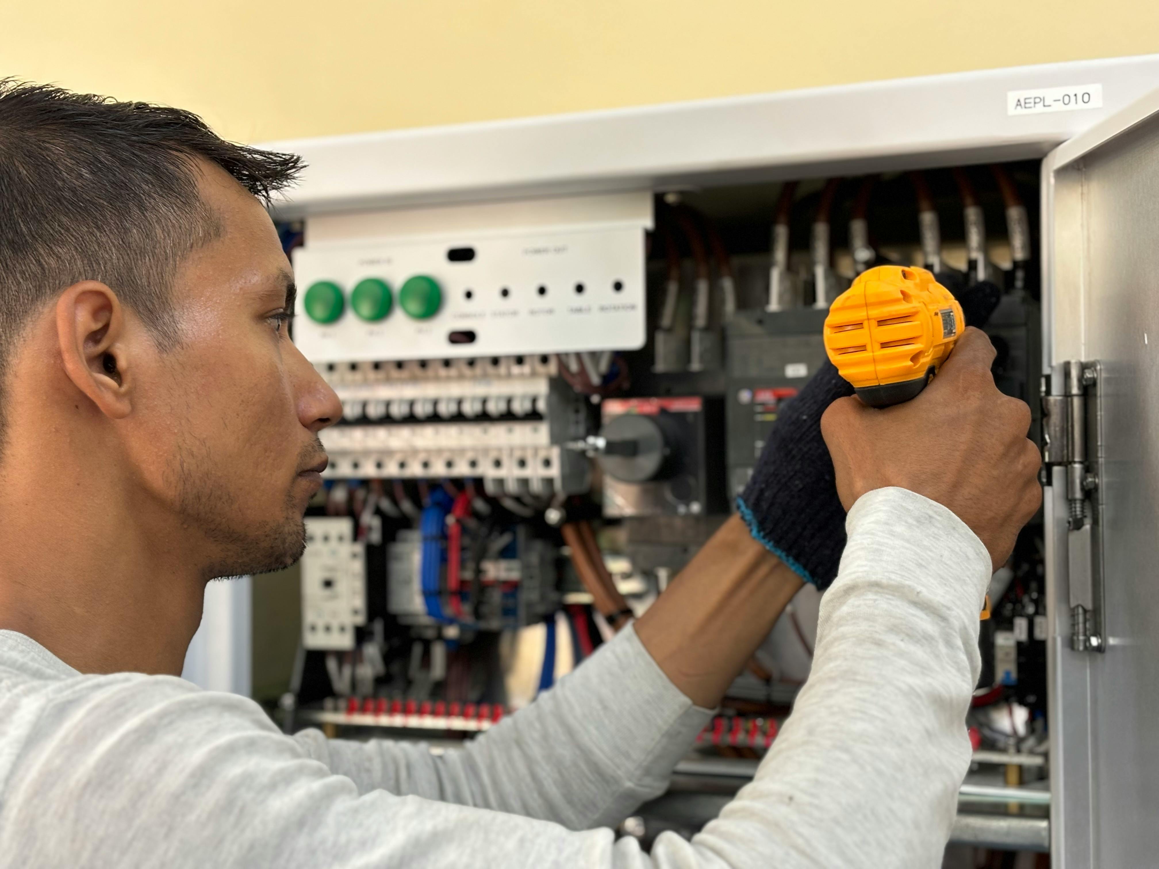 Electrician working inside electrical panel — electrician resume article